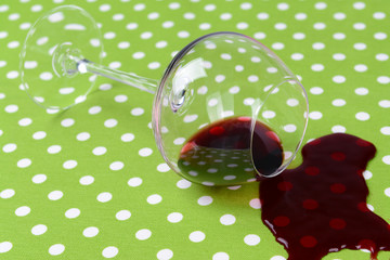 Overturned glass of wine on table close-up