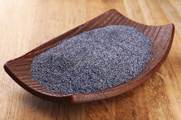 Poppy seeds in bowl on table close-up