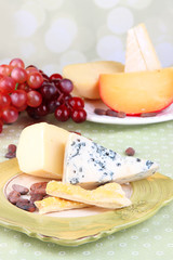 Assorted cheese plate , grape, bread sticks.