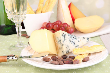 Assorted cheese plate , grape and wine glass