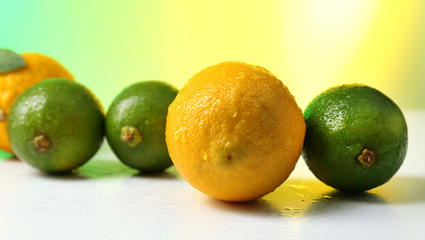 Lemons and limes on bright background