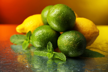 Lemons and limes on bright background