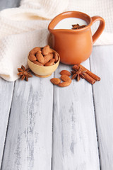 Almond milk in jug with almonds in bowl,