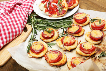 Small pizzas on baking paper close up