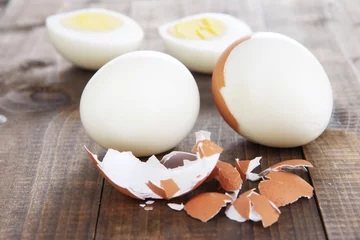 Tuinposter Peeled boiled egg on wooden background © Africa Studio