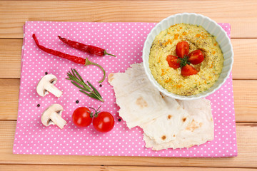 Bowl of tasty fresh hummus, close up