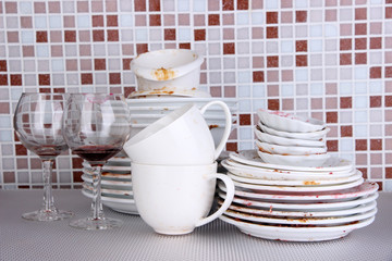 Dirty dishes on bright background