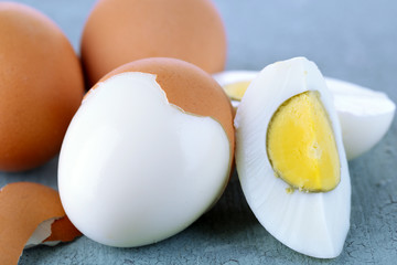 Boiled eggs on color wooden background