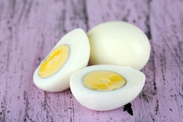 Boiled eggs on color wooden background