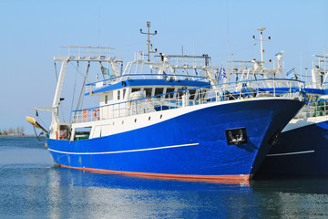 Fishing ships docked in port - 63191279