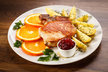 Grilled steak, boiled potatoes and lingonberry jam