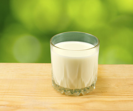 image of a glas of milk on a green background