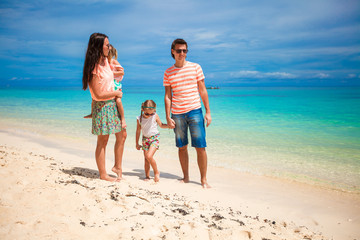 Young beautiful family with two kids on tropical vacation
