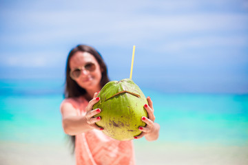 Fototapeta premium Closeup a coconut in hands of young girl