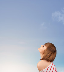 Obraz premium Girl looking at the blue sky copyspace