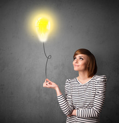 Woman holding a lightbulb balloon