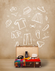 Traveler luggage with hand drawn clothes and icons