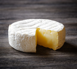 Camembert cheese on a wooden board