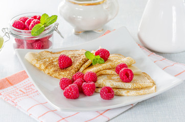Homemade pancakes with raspberries and mint