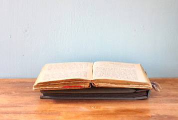 open old book over wooden shelf