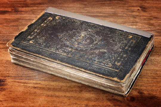 antique book over wooden table  