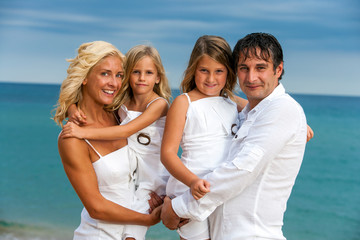 Happy family portrait on beach.