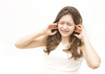 distraught woman covering her ears with her hands