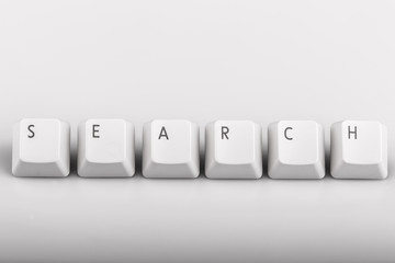 text search formed with computer keyboard keys on white backgrou
