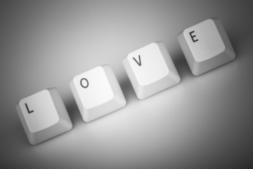 text love formed with computer keyboard keys on white background