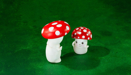 cute puppets handmade, two mushrooms, green background