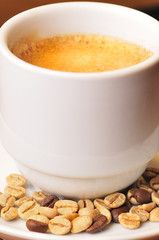 Coffee cup with grains in the wood table