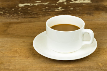 Coffee cup on old wooden table