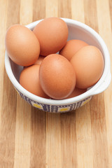 Chicken eggs in a traditional ceramic bowl