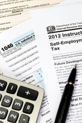 Tax form and instruction with pen, and calculator taxation conce