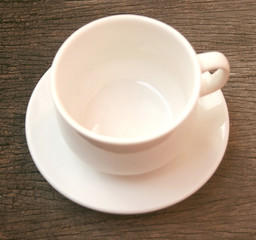 Empty coffee cup on old wooden table