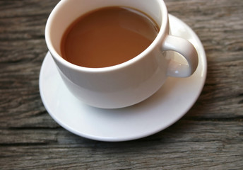 coffee in a white cup on wooden