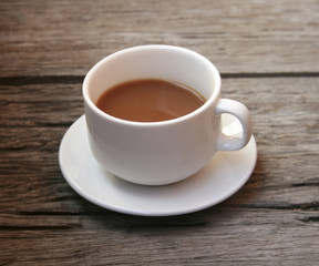 coffee in a white cup on wooden