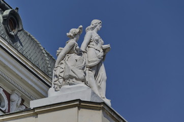 Fototapeta na wymiar Two woman sculpture on building