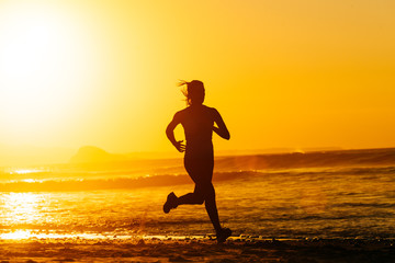 Fototapeta na wymiar Epic runner training on summer sunset