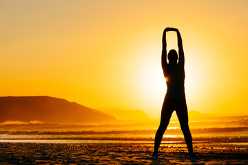 Woman exercising on beautiful sunset