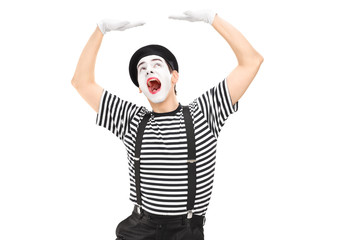 Mime artist simulate carrying something over his head