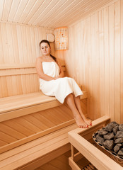 vSexy brunette woman at sauna sitting with closed eyes