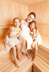 Photo of mother with two daughters relaxing at sauna
