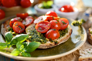 Bruschetta with fresh cherry tomatoes and aromatic herb pesto