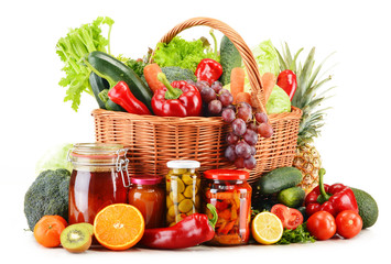 Wicker basket with groceries isolated on white