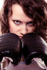 Sport boxer woman in gloves. Fitness girl training kick boxing.