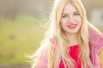 portrait of blond woman in red maxi dress