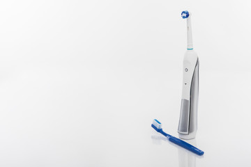 Dental Health Concept: Electric Toothbrush Against Manual Toothb