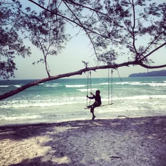 Fotobehang child on home made swing under tree on beack in cambodia © turleyt