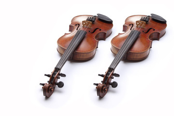 Two violins on white background.